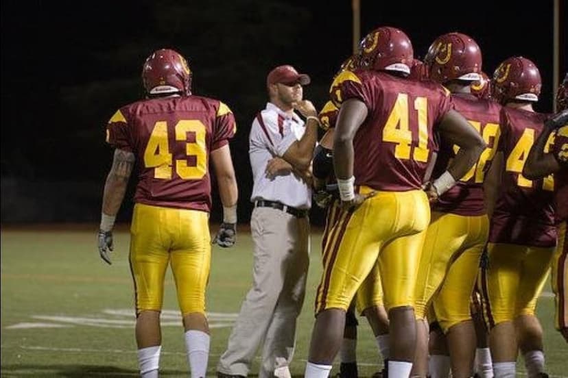 On the football sideline during a night game